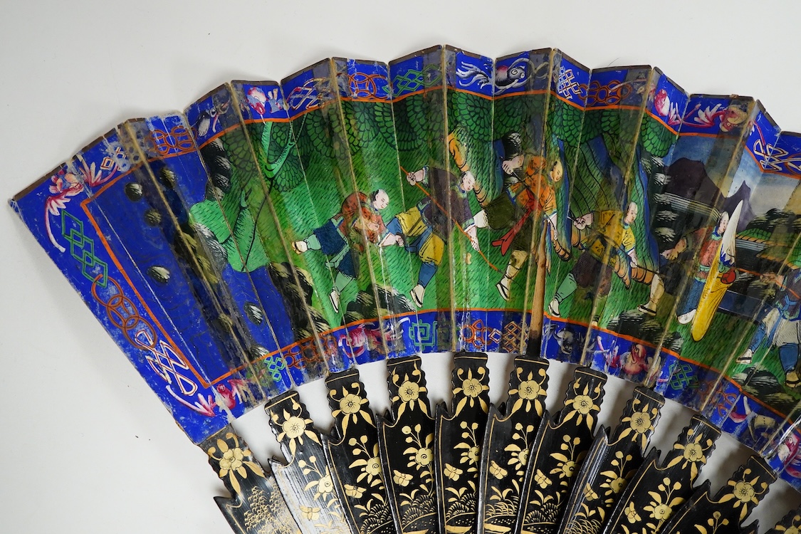 Four 19th century Chinese gilt-decorated black lacquer fans with figure painted leaves, two cased, largest 41cm
